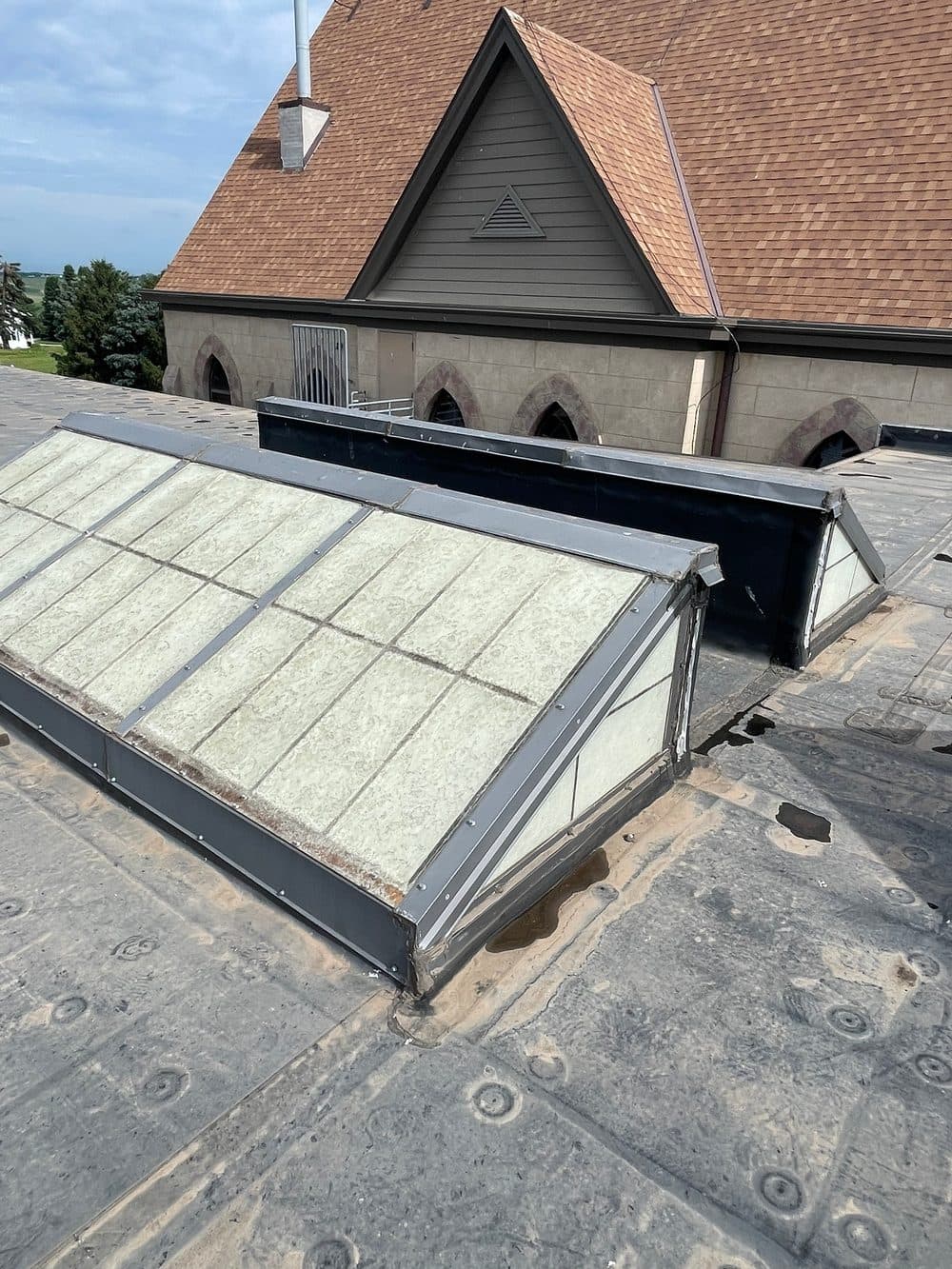 Before: weathered commercial roof skylights
