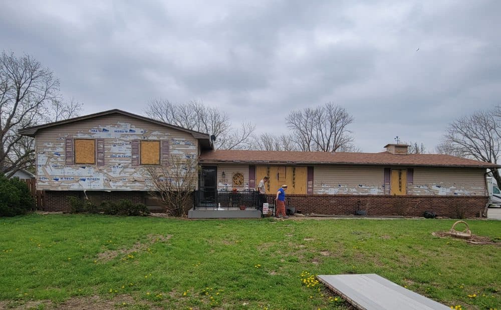 Before: old siding stripped, house mid-project