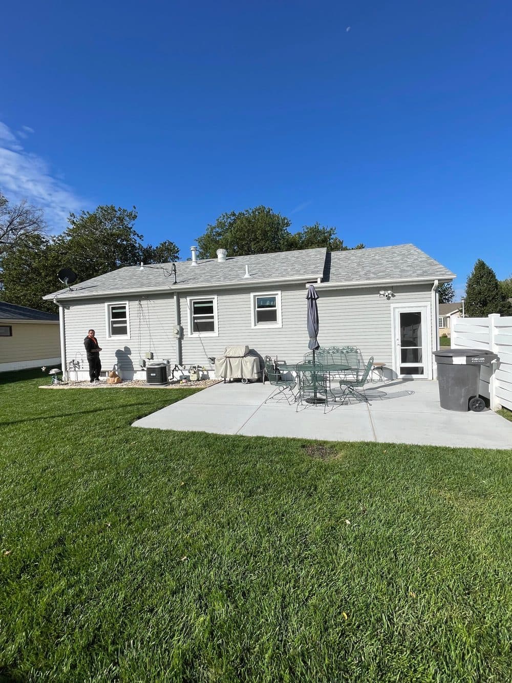 After: new gray shingle roof completed