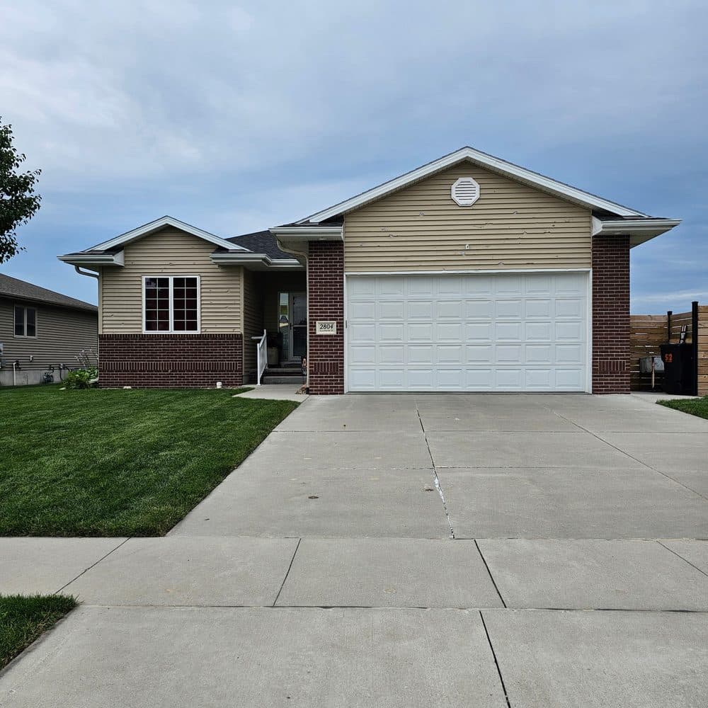 Before: tan siding and brick exterior