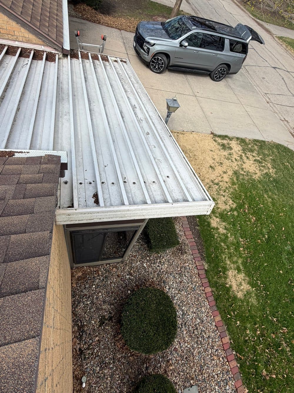 Before: worn metal breezeway roof panel